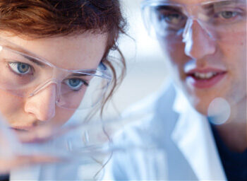 Researchers with safety glasses